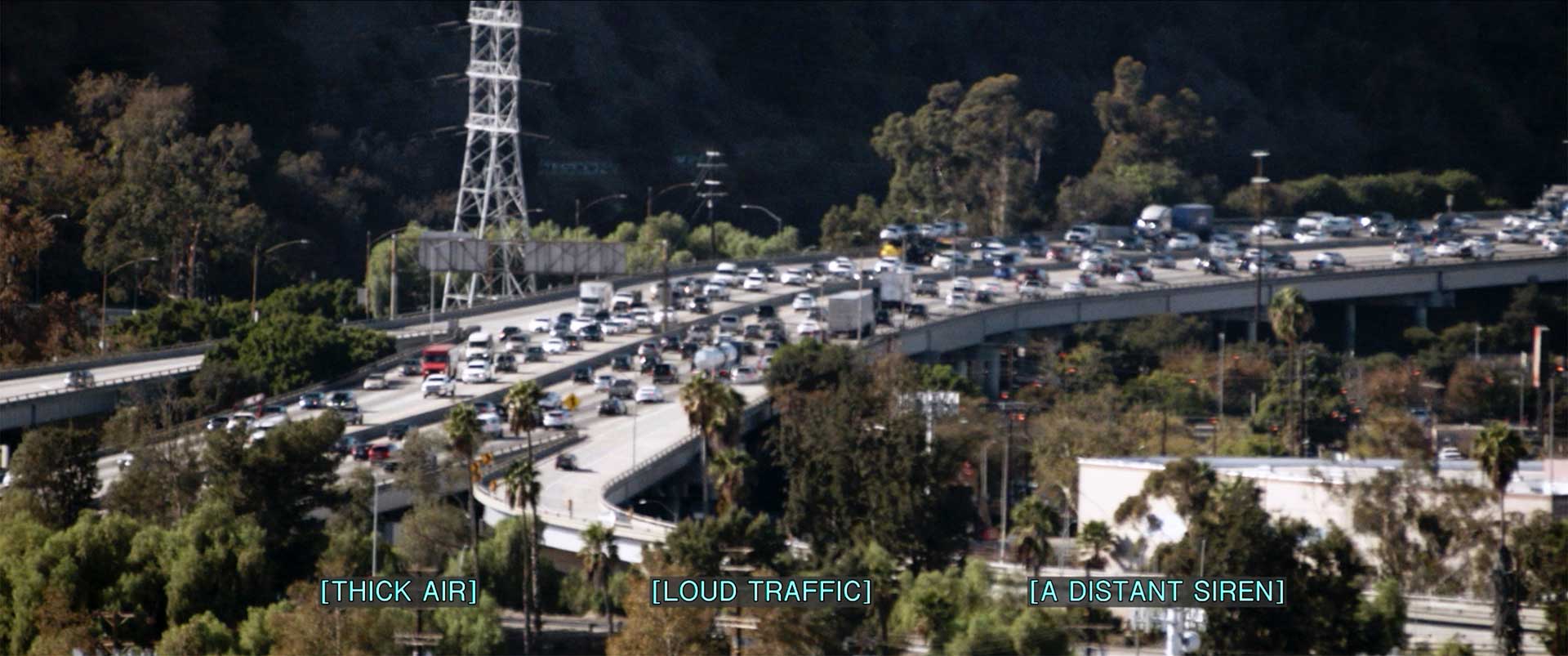 Scene of los angeles traffic jam, with the captions "thick air, loud traffic, a distant siren"